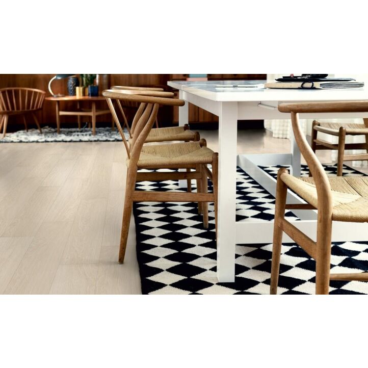 parquet laminado roble danés moderno de la marca pergo de la serie living expression sensation resistente al agua superficialmente l0331-03372 en un ambiente de habitación con una alfombra.