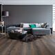 Parquet laminado de roble desierto marrón oscuro cepillado de la marca quick-step de la serie majestic en un ambiente de habitación.