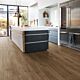 Parquet laminado de roble newcastle marrón de la marca quick-step de la serie eligna en un ambiente de habitación.