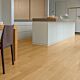 Parquet laminado de  de roble barnizado natural EL896 la marca quick-step de la serie eligna en un ambiente de habitación.