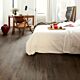 Parquet laminado de robe clásico marrón de la marca quick-step de la serie impressive en un ambiente de habitación.