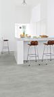 Parquet vinílico de la marca Quick-Step livyn hormigón gris cálido AMCP40050 de la serie Ambient Click Plus en un ambiente de habitación.