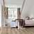 Parquet laminado de roble desierto gris cepillado de la marca quick-step de la serie majestic en un ambiente de habitación.